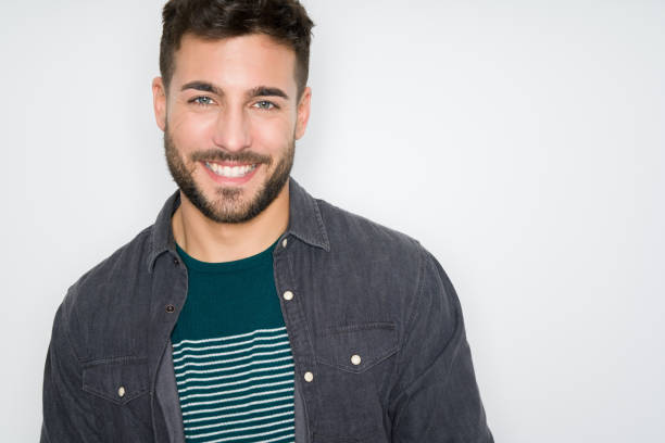 istock Young handsome man posing and modeling over grey isolated background 1139065436