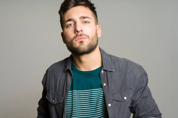 istock Young handsome man posing and modeling over grey isolated background 1139065451