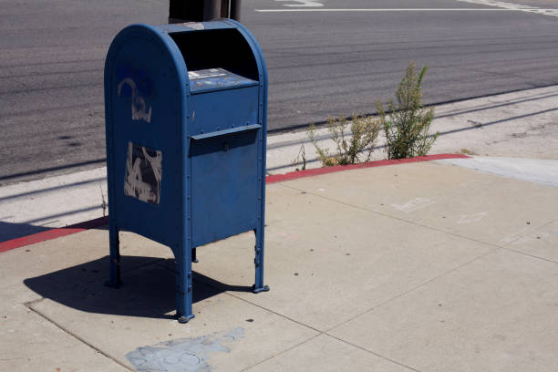USA. Urban scene. One od set. Mailbox and weeds on sidewalk. blue mailbox stock pictures, royalty-free photos & images