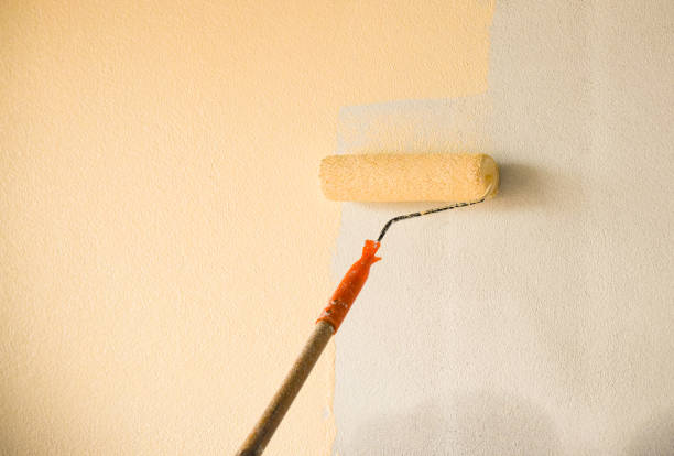 istock Hand painting wall background with paint roller on building construction site interior decoration 1139065768