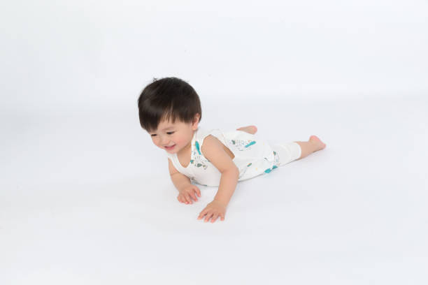istock adorable boy crawls on all fours studio shot 1139069572