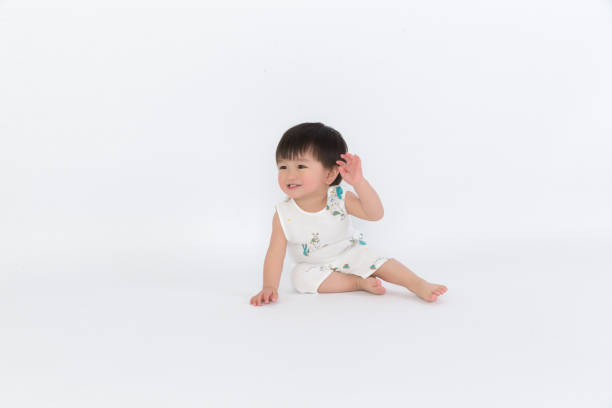 istock Happy child is sitting on floor, isolated over white 1139069587