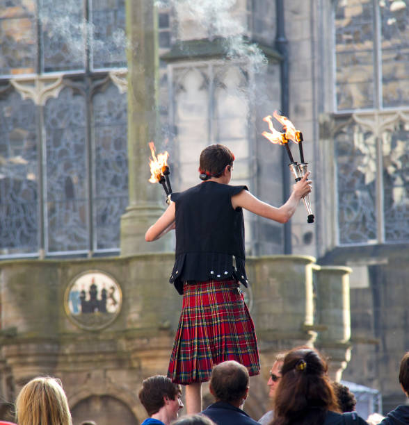 Fire torch juggler on the Edinburgh Festival Fringe in Edinburgh, UK on August 2, 2012