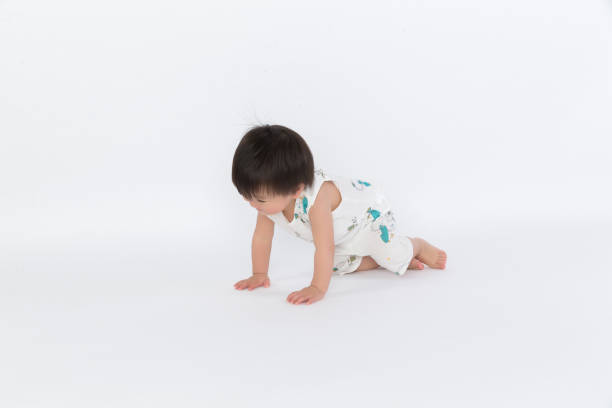 istock adorable boy crawls on all fours studio shot 1139070240