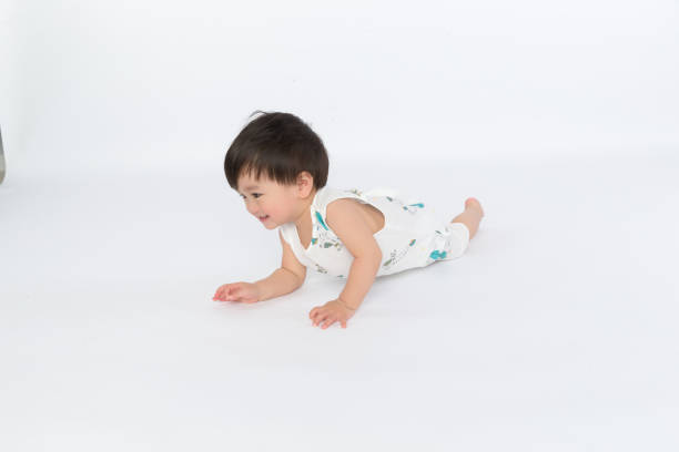 istock adorable boy crawls on all fours studio shot 1139070281
