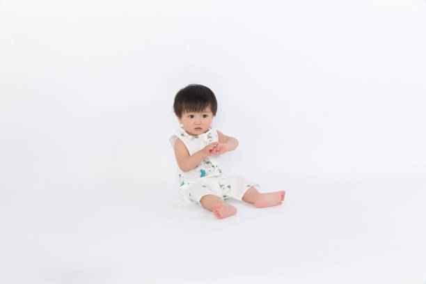 istock Happy child is sitting on floor, isolated over white 1139070342