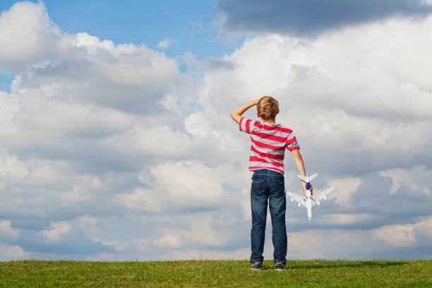 Young boy playing with a toy plane