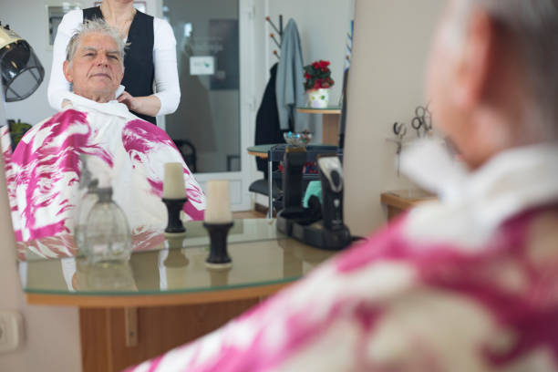 istock Senior Man at Hair Salon Looking in Mirror 1139074663