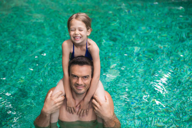 istock Joyful father and kid swimming together 1139076635