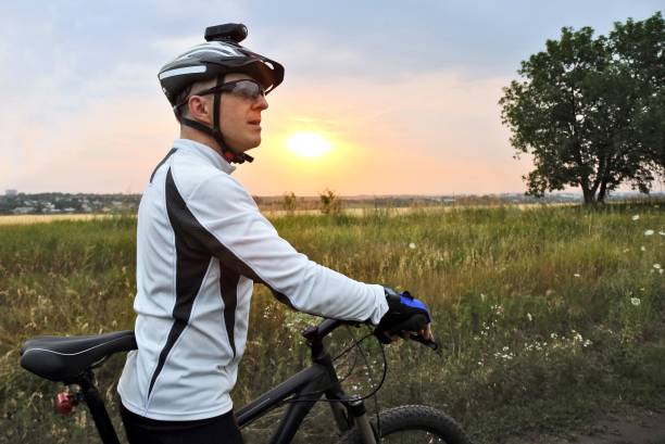 istock cyclist with Bicycle standing on field path 1139077223