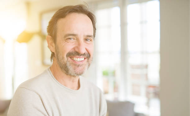 istock Handsome middle age man smiling looking at the camera at home 1139078476