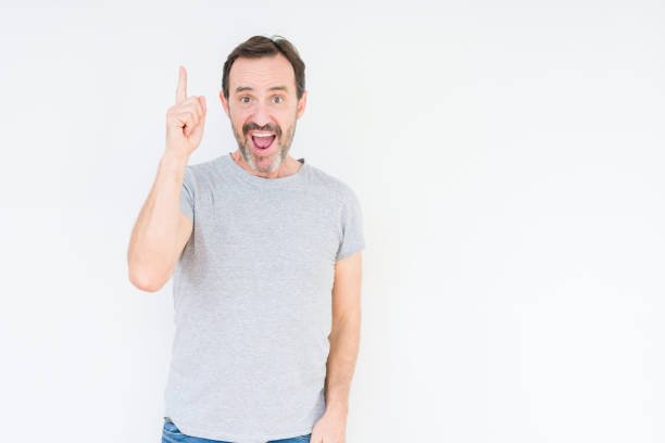 istock Handsome senior man over isolated background pointing finger up with successful idea. Exited and happy. Number one. 1139078491