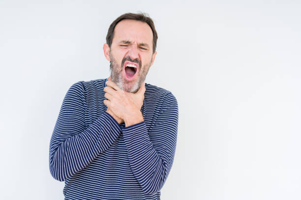 istock Handsome senior man over isolated background shouting and suffocate because painful strangle. Health problem. Asphyxiate and suicide concept. 1139078516