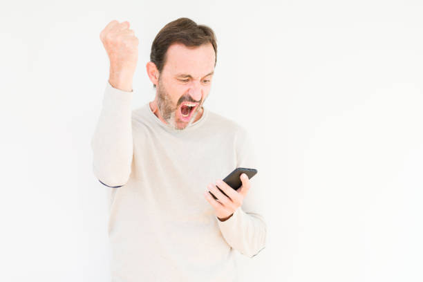istock Senior man using smartphone over isolated background annoyed and frustrated shouting with anger, crazy and yelling with raised hand, anger concept 1139078538