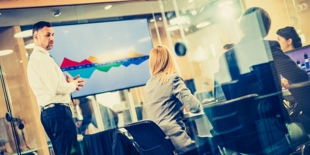 istock Caucasian financial advisor giving forecast to board members 1139078934