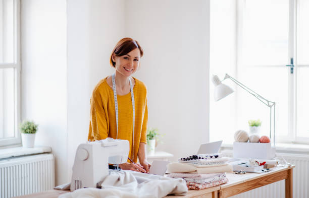 Young creative woman in a studio, startup of small tailoring business.