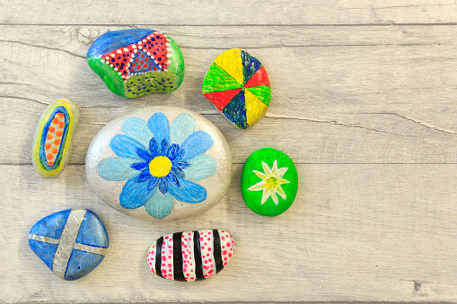 Painted stones on a shabby style board