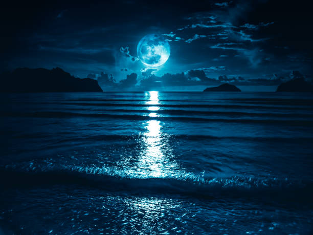 Super moon. Colorful sky with bright full moon over seascape. stock photo