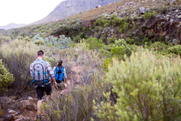 istock Young couple hiking on mountain trail 1139081639