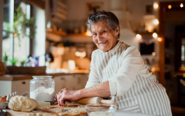 istock Elderly woman making cakes in a kitchen at home. Copy space. 1139082295