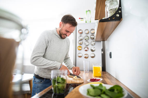istock Young Caucasian man preparing a healthy fruit breakfast in the kitchen 1139083897