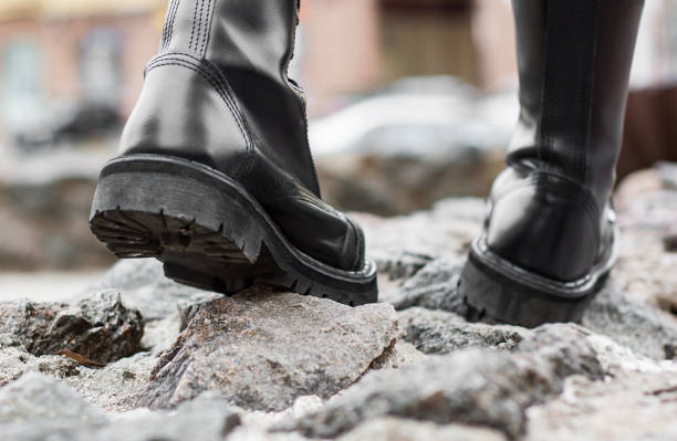 istock Close up view sole black leather boot on stone nature background outdoor 1139084447