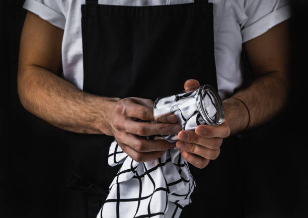 Restaurant personnel Waiter wiping clear glass. Restaurant staff. Service sector. apron stock pictures, royalty-free photos & images