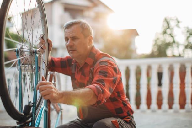 istock Senior man repairing bicycle in back yard 1139087486