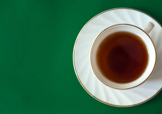 cup of tea on green background with copy space - tea cup cup old fashioned china imagens e fotografias de stock