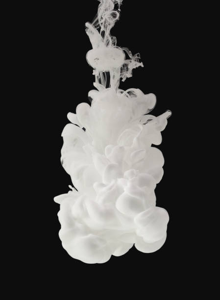 White paint flowing in water isolated on black