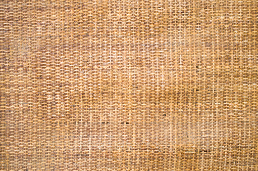 Old dirty orange wicker rug closeup