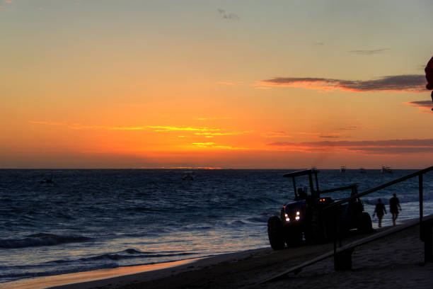 istock Tractor cleaning beach during sunrise. 1139094945