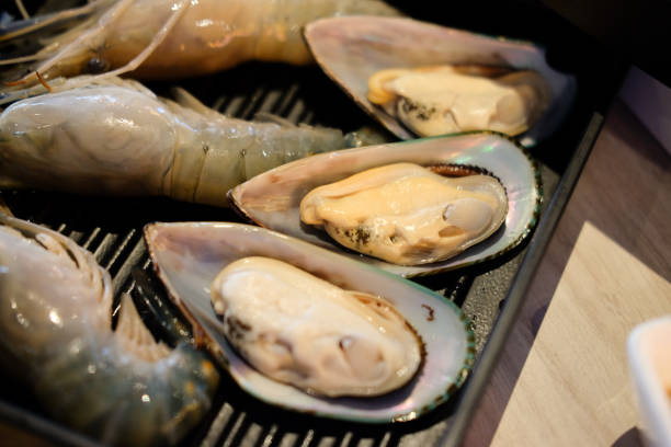 istock Fresh raw shrimp and mussel on black tray ready to cook 1139095048