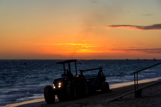 istock Tractor cleaning beach during sunrise. 1139095196