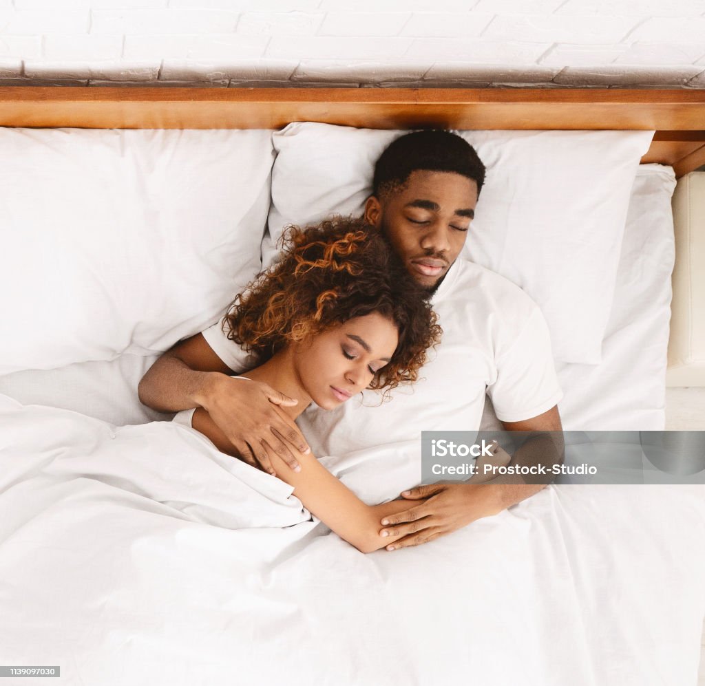 Loving Couple Sleeping In Bed And Hugging Stock Photo - Download ...