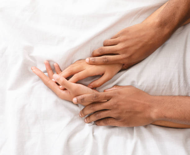 Man and woman hands having sex on bed Make love. African-american male and female hands on bed, closeup orgasm women female sexual issues stock pictures, royalty-free photos & images