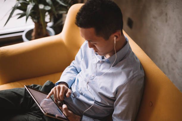 istock Millennial man listening and watching vodcast 1139097735