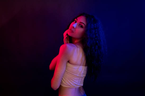 istock Attractive female in blue and red light 1139098213