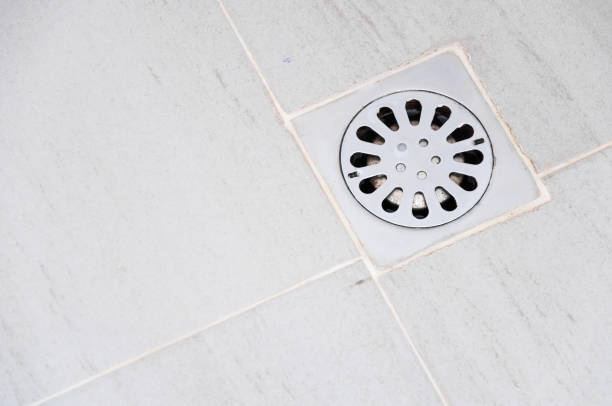 Old chrome shower drain set in on a shower