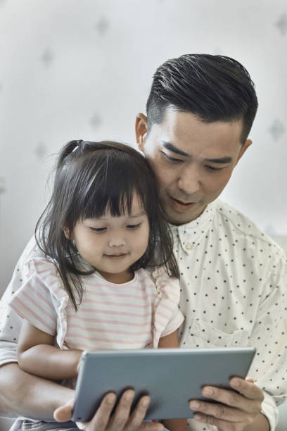 istock Father and child watching movie in digital tablet 1139102789