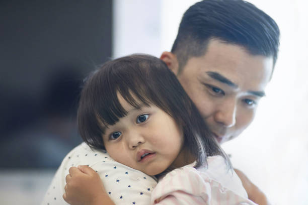 istock Daughter shedding teardrops on father at home 1139103039