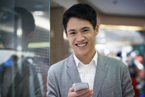 istock Portrait of cheerful man using phone in mall 1139105544