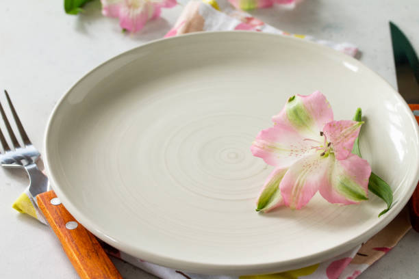 istock Spring or Mother's Day table setting. Plate, cutlery and napkin on white stone table. Copy space. 1139106184