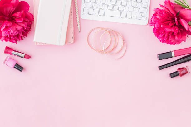 istock Flat lay blogger or freelancer workspace with a notebook, keyboard, red peonies on a pink background 1139106247