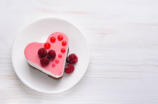 nice small cake in the form of heart  on the table