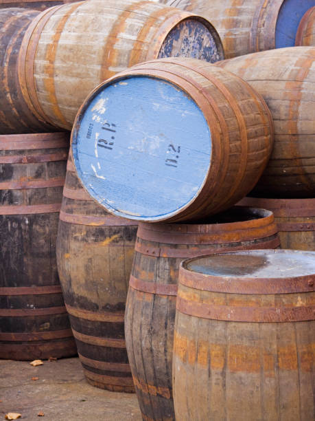 istock Old beer casks stacked in a brewery yard UK 1139106573