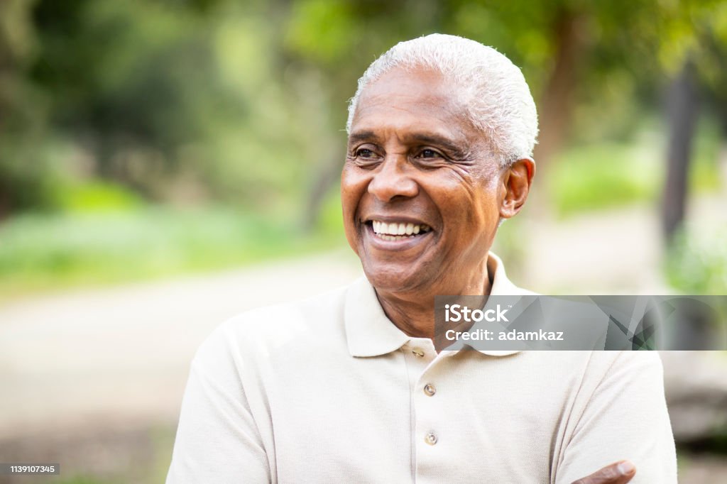 Smiling Senior Black Man Outdoors A portrait of a senior black man Senior Adult Stock Photo