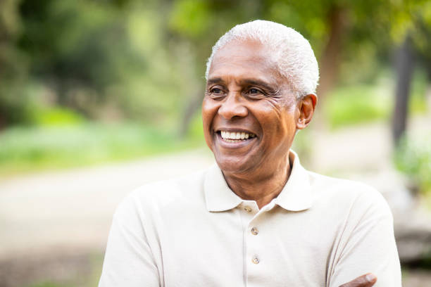 Smiling Senior Black Man Outdoors A portrait of a senior black man south east asian ethnicity stock pictures, royalty-free photos & images
