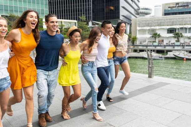istock Friends walking in a row, arms around shoulder 1139107833