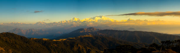 Dramatic landscape Kangchenjunga mountain with colorful from sunlight at Sandakphu Dramatic landscape Kangchenjunga mountain panorama with colorful from sunlight at Sandakphu, north of India kangchenjunga stock pictures, royalty-free photos & images